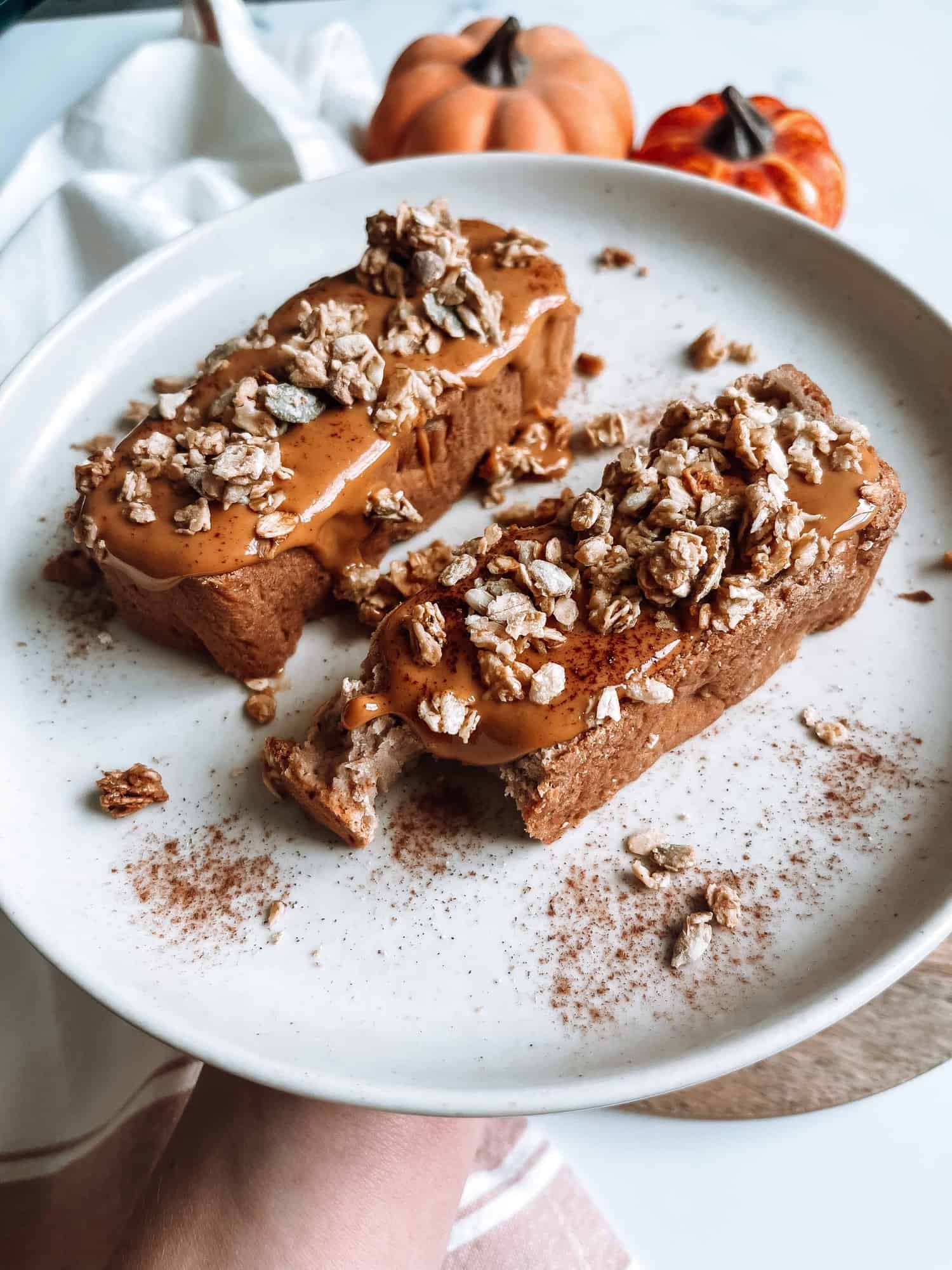 slices of vegan banana bread topped with peanut butter and granola