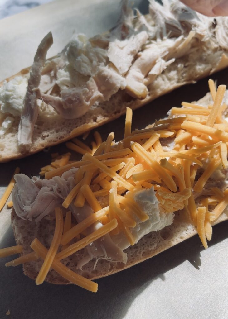 Flatbread pizza with chicken, cheese and bbq sauce being made