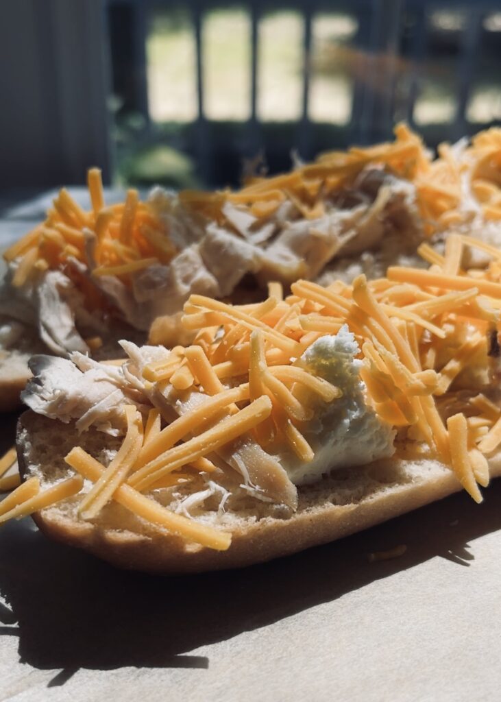 Flatbread pizza with chicken, cheese and bbq sauce being made