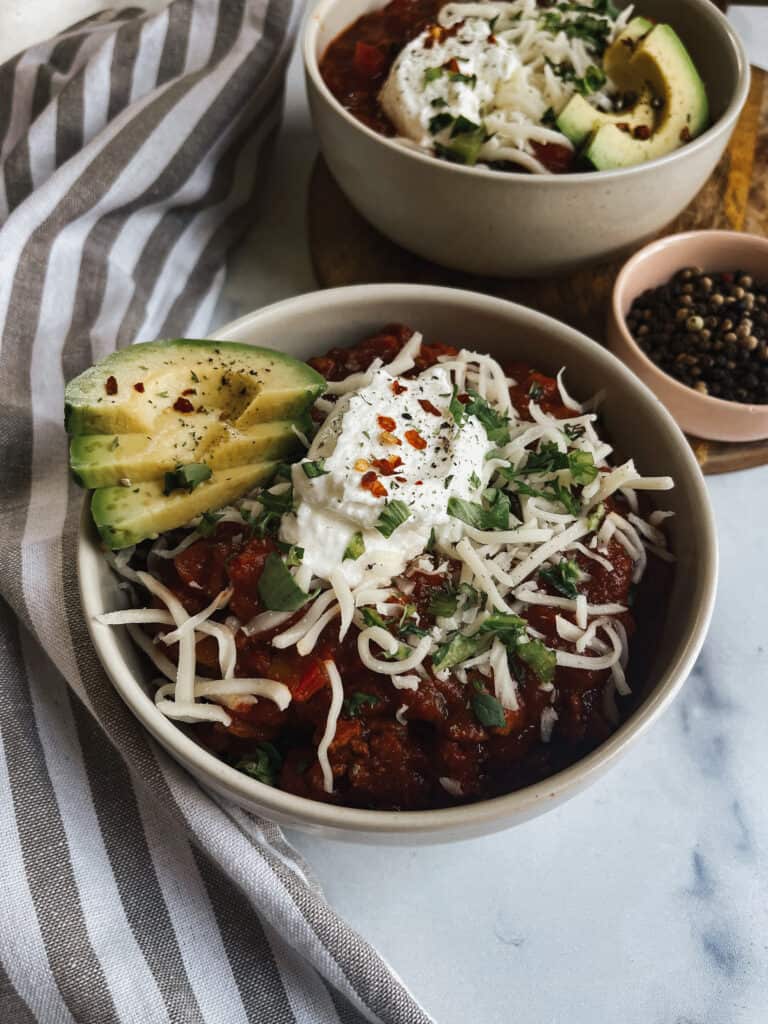 turkey chili topped with cheese and avocado