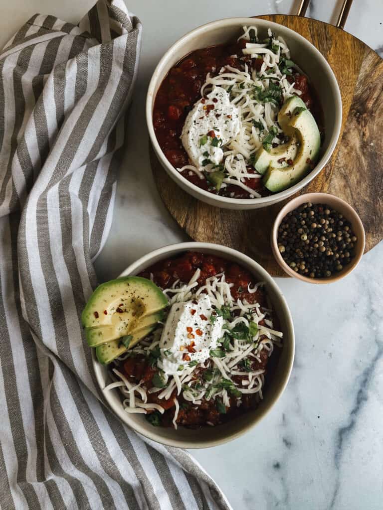 turkey chili topped with cheese and avocado