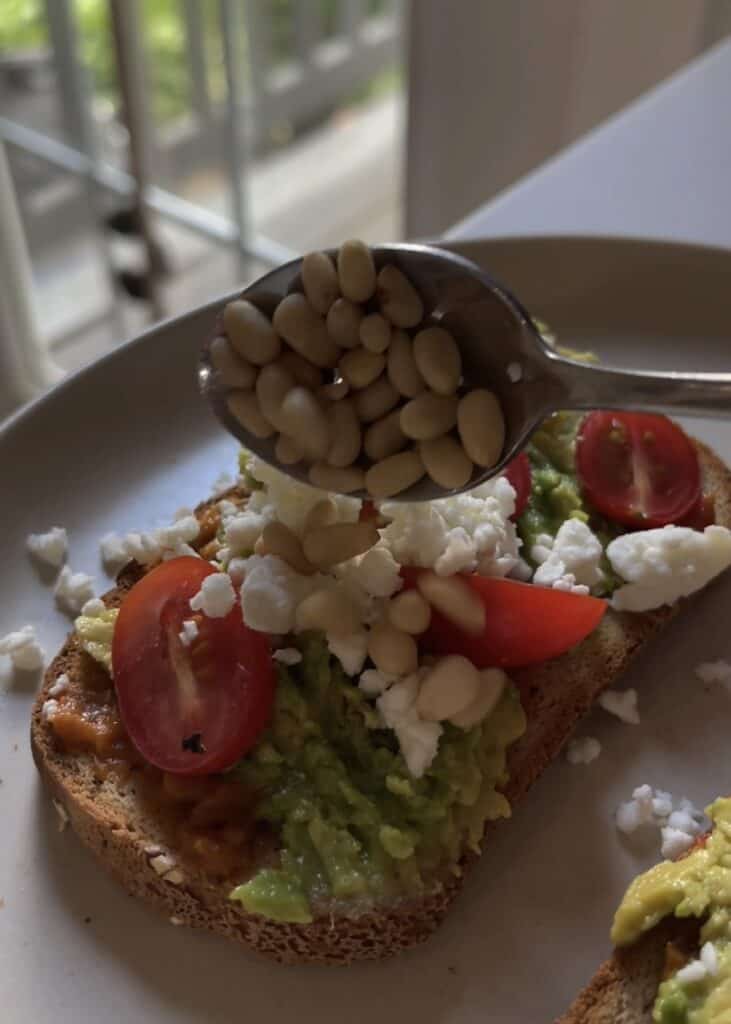 feta avocado toast on gluten free bread with pine nuts