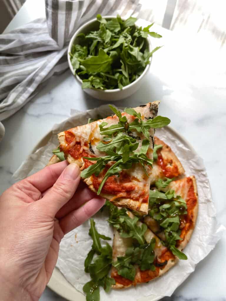gluten free Roasted red pepper pizza with arugua and hot honey