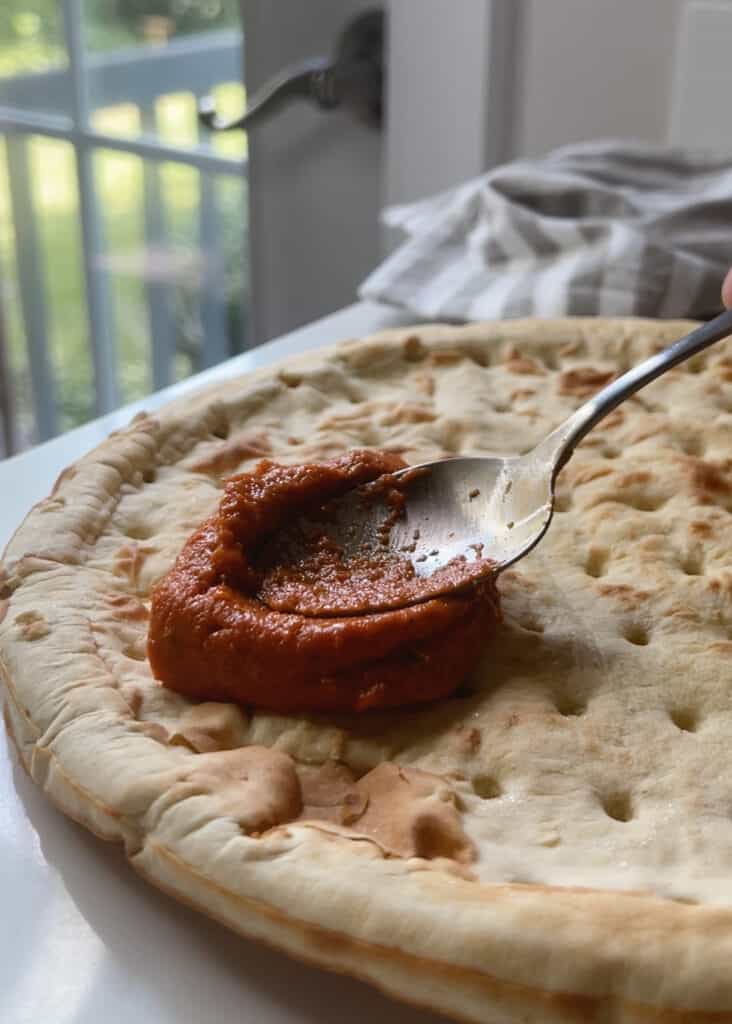 Roasted red pepper sauce on pizza crust