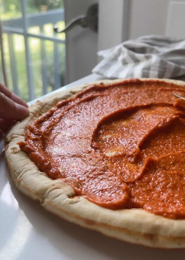 Roasted red pepper sauce on pizza crust