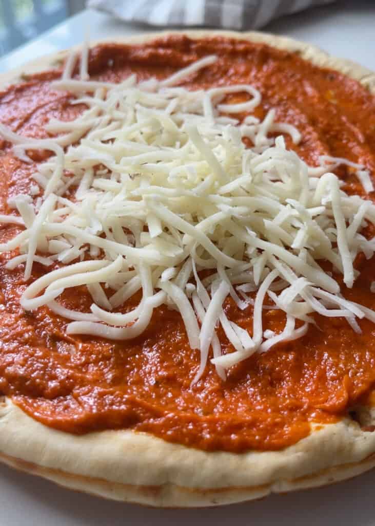 preparing the roasted red pepper pizza on gluten free crust