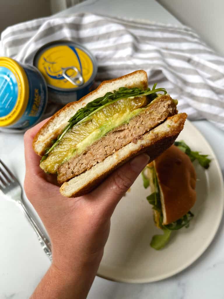 Healthy Tuna patty on a bun with arugula, pineapple and avocado