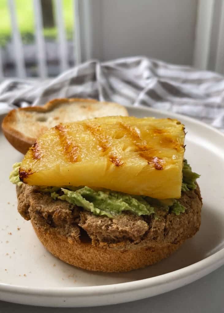 gluten free burger bun with tuna patty and avocado and pineapple