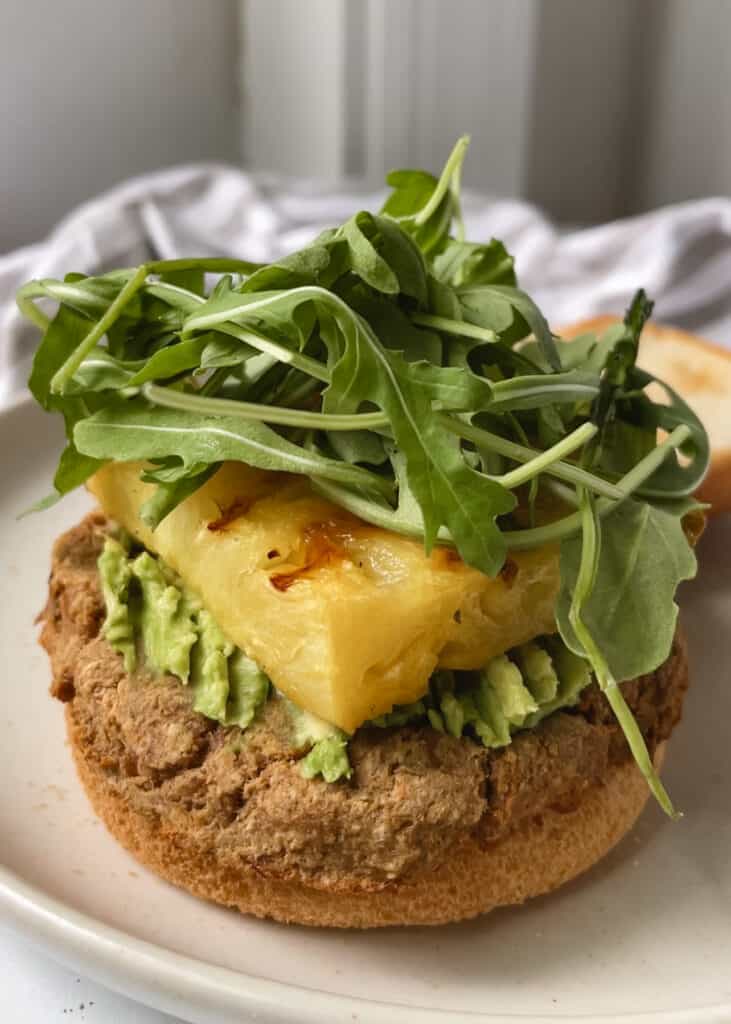 gluten free burger bun with tuna patty and avocado and pineapple 