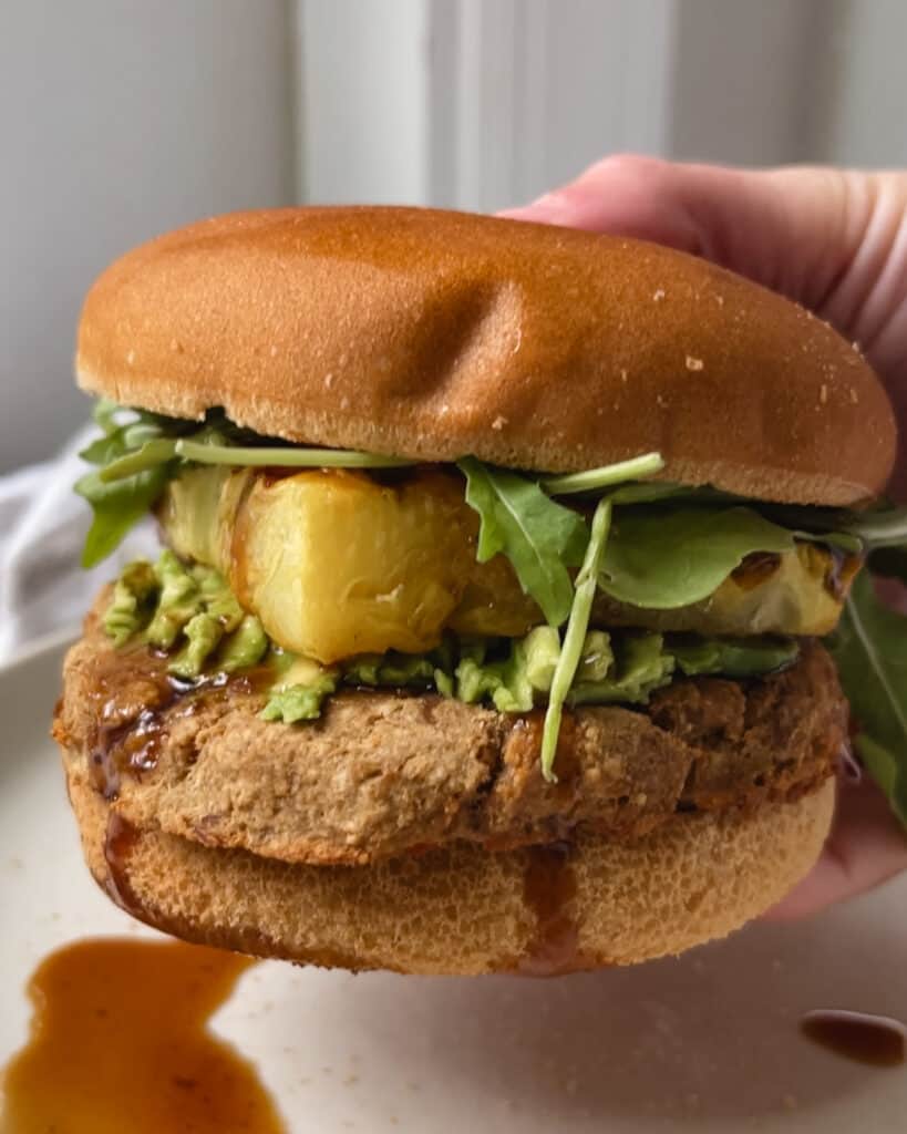 gluten free burger bun with tuna patty and avocado and pineapple and korean bbq sauce