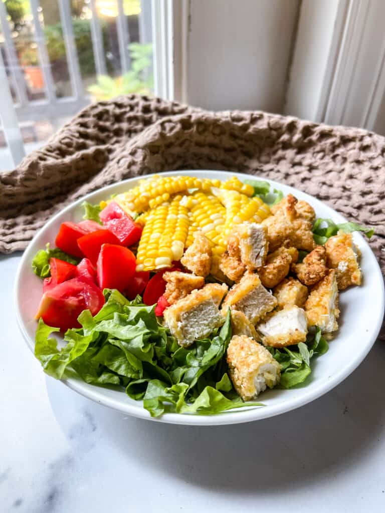 Salad with chicken tenders and honey mustard