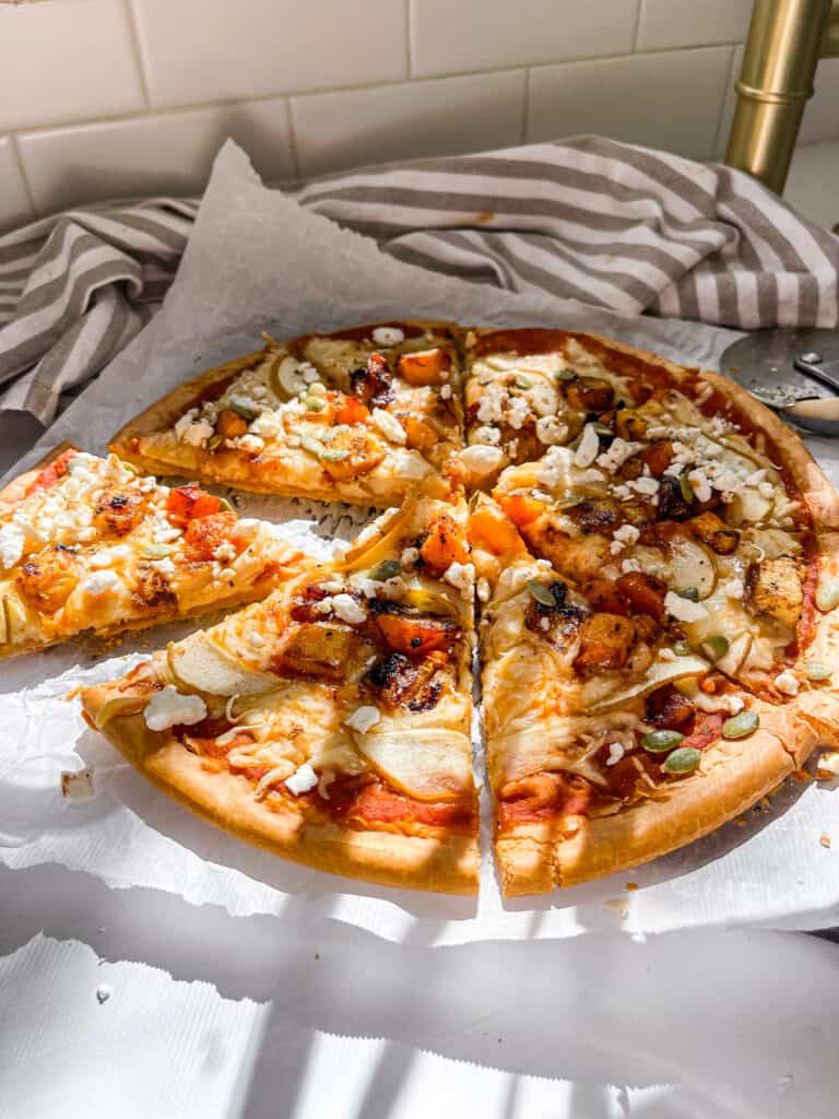feta pizza with a gluten free pizza crust with pumpkin sauce and mozzarella cheese