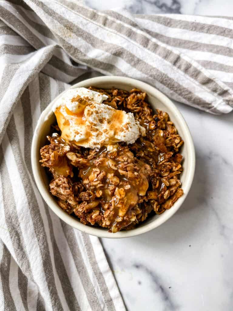 gluten free apple cobbler with oats, caramel and whipped cream