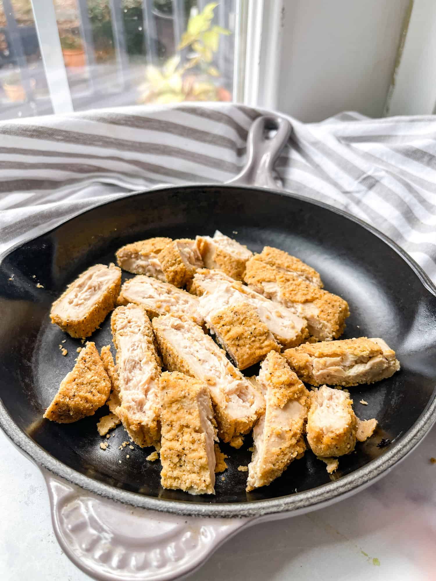Gluten Free Chicken Parmesan skillet with basil