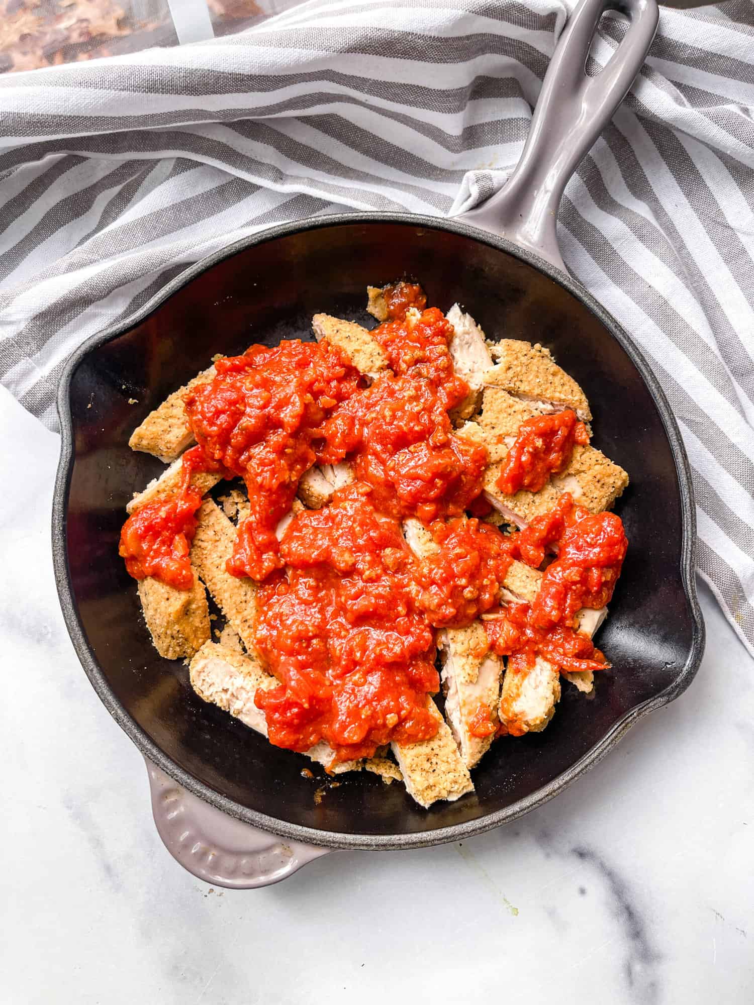 Gluten Free Chicken Parmesan skillet with basil