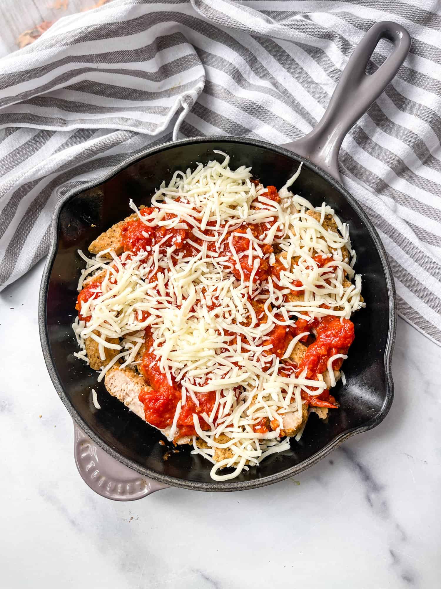 Gluten Free Chicken Parmesan skillet with basil