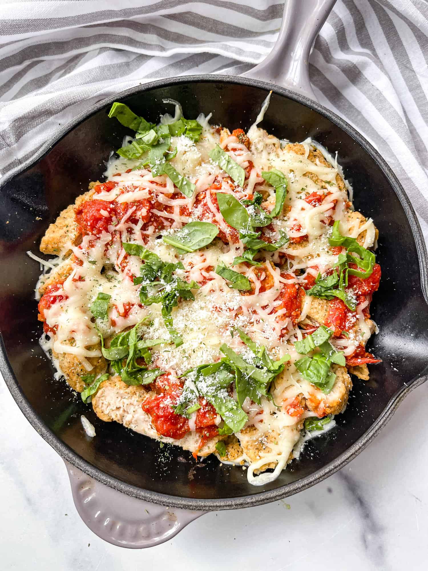 Gluten Free Chicken Parmesan skillet with basil