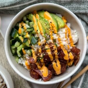 Poke bowl with avocado, tuna, cucumber and a drizzle of spicy mayo