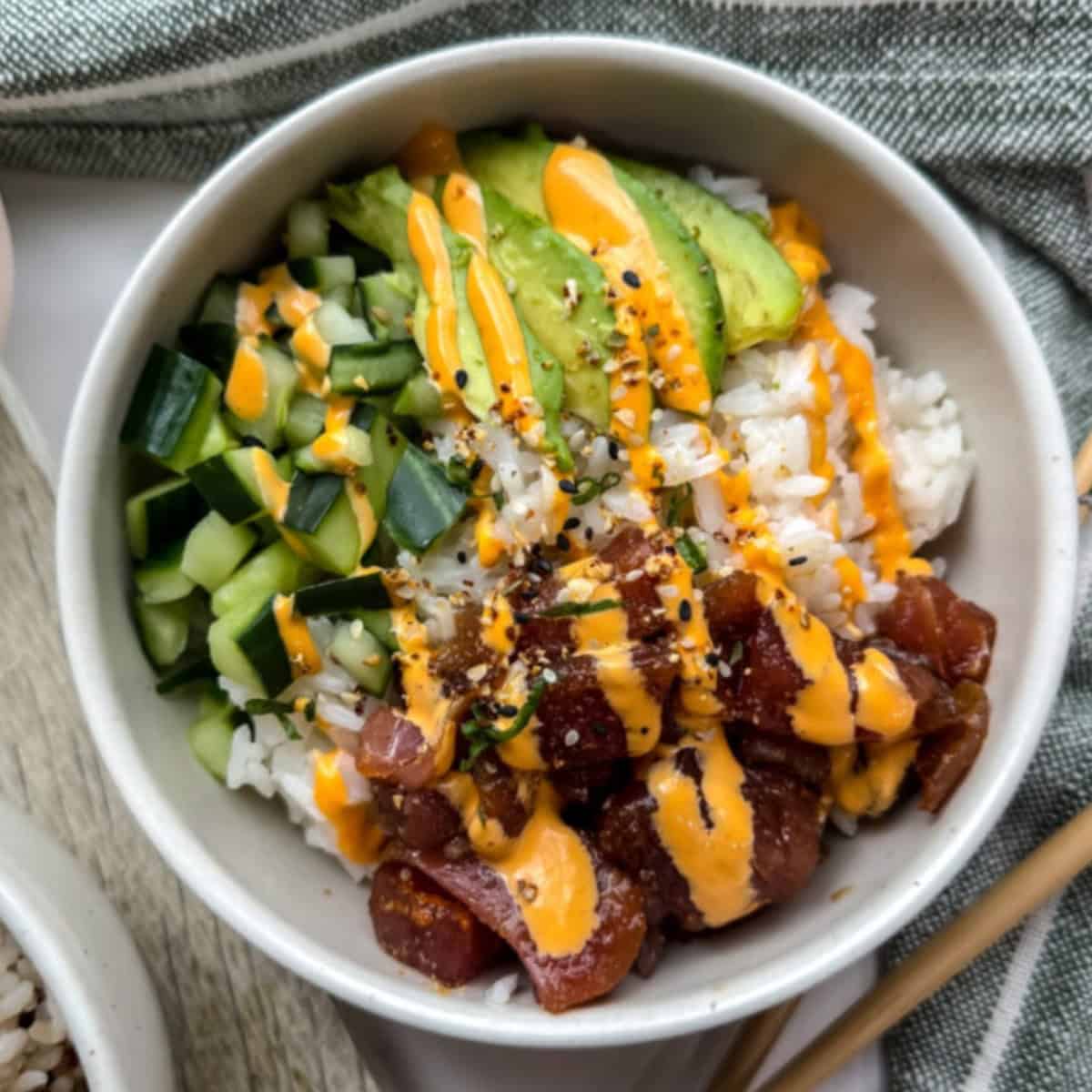 Poke bowl with avocado, tuna, cucumber and a drizzle of spicy mayo