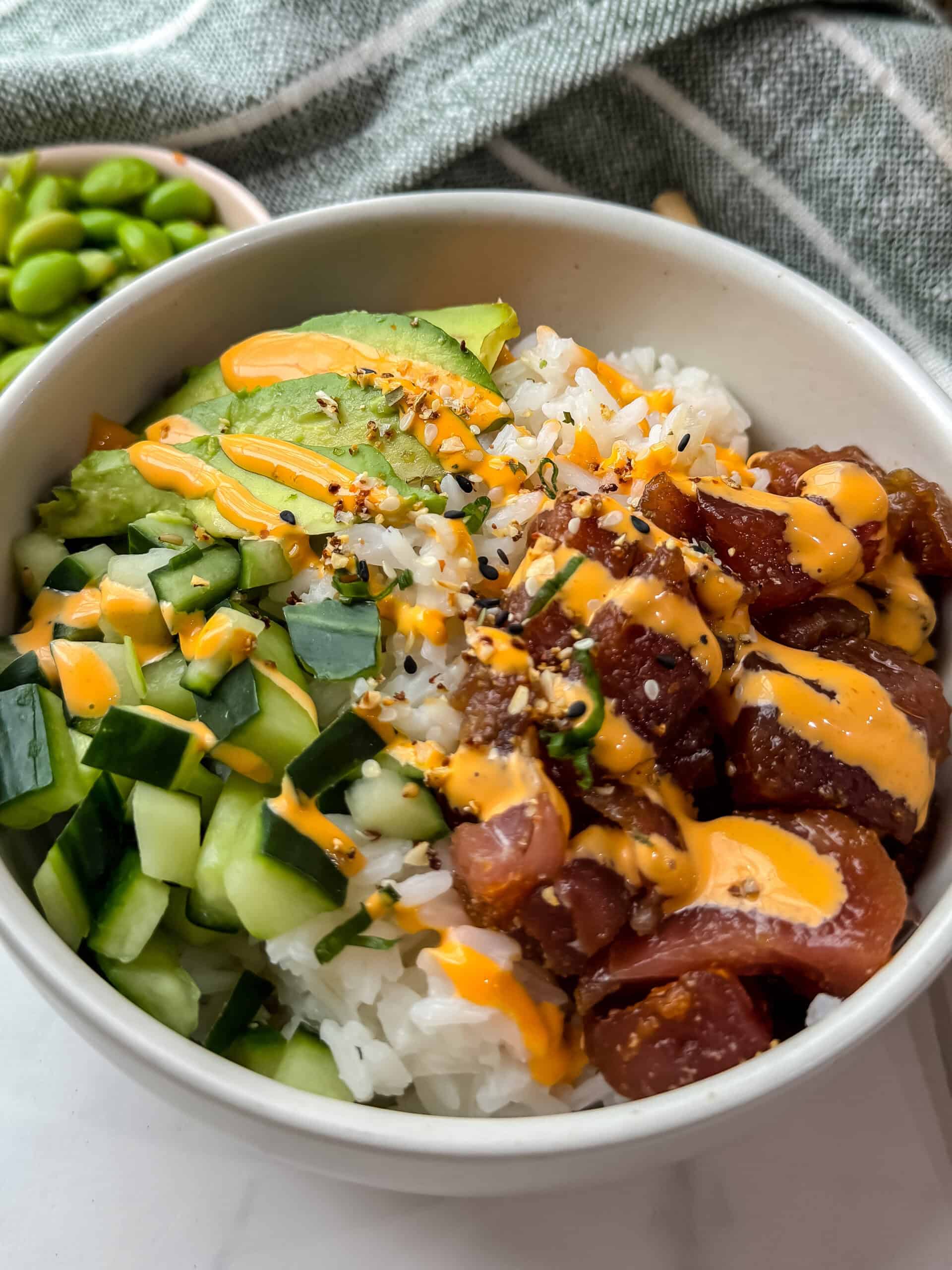 Poke bowl with avocado, tuna, cucumber and a drizzle of spicy mayo